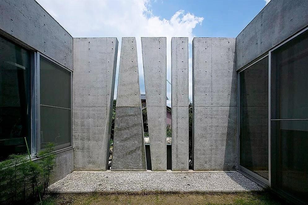 High-tech concrete steles on a garden plot