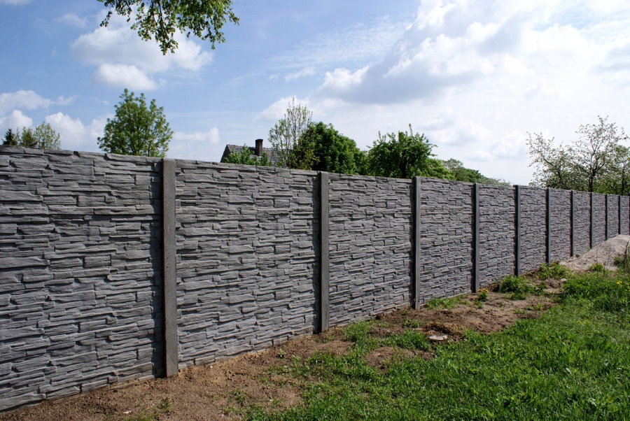 Gray concrete fence at their summer cottage
